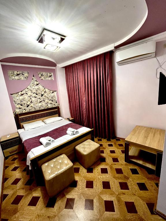 a hotel room with a bed and a table at Georgian Palace Hotel in Kutaisi