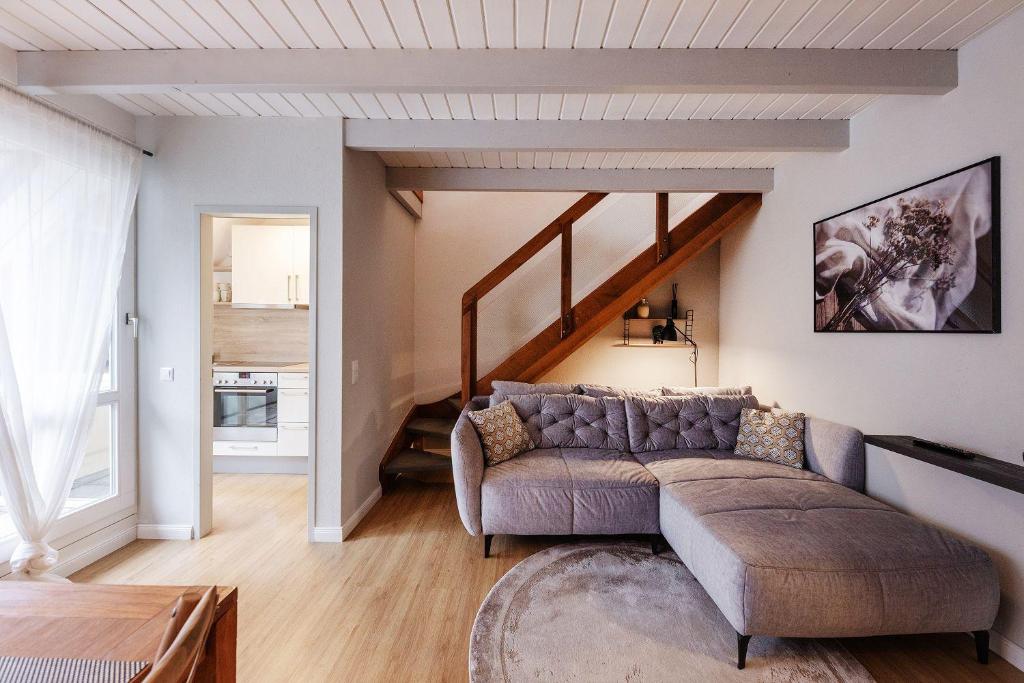 a living room with a couch and a staircase at Karbon in Münster