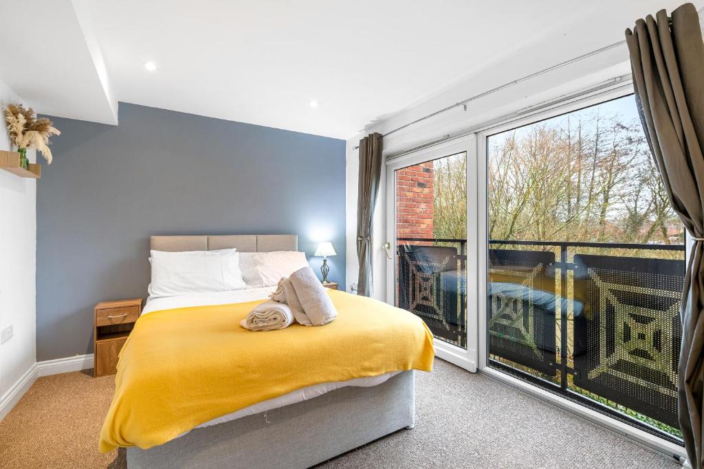 a bedroom with a bed and a large window at River View House in Lincoln