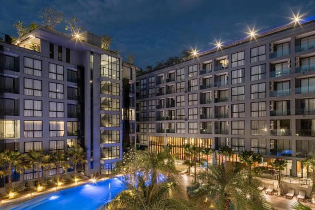 an image of a building with a swimming pool at night at Modern Condo in Boutique Style Resort CGB4 in Phuket Town