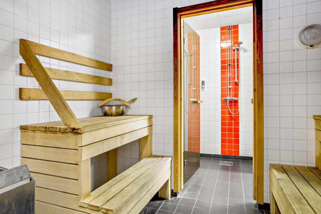 a bathroom with a bench and a shower at Sure Hotel by Best Western Stockholm Alvsjo in Stockholm