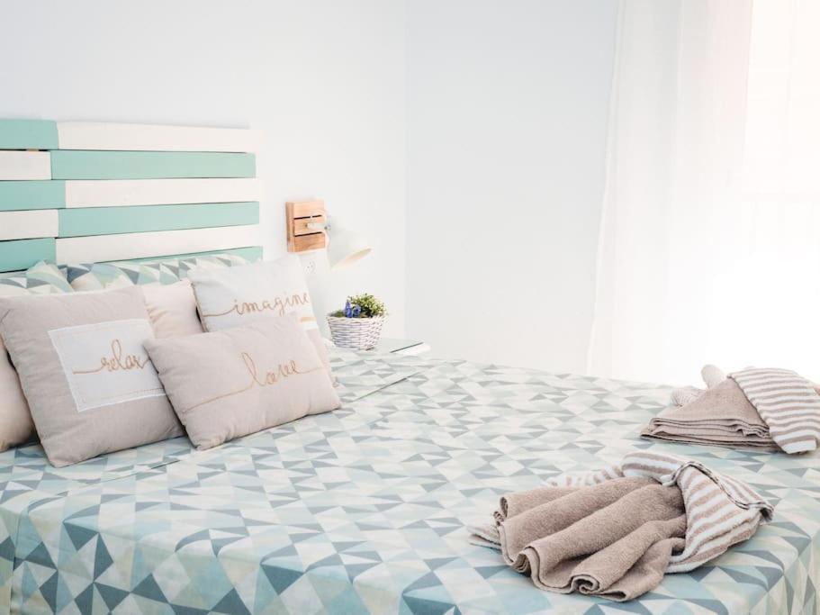 a bedroom with a large bed with towels on it at Precioso apartamento en el Calón Playa con vistas y piscina in El Calón