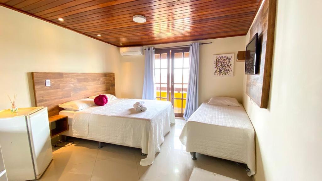 Un pat sau paturi într-o cameră la Pousada dos Atobás