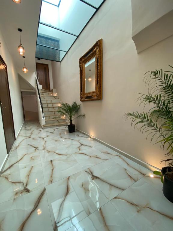 a hallway with a mirror and a marble floor at Riad Jbara 2 in Rabat