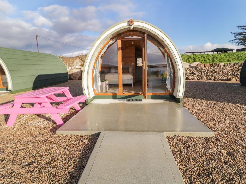 a small dome tent with a pink picnic table in front of it at The Wheelhouse Pod No 7 in Letterkenny