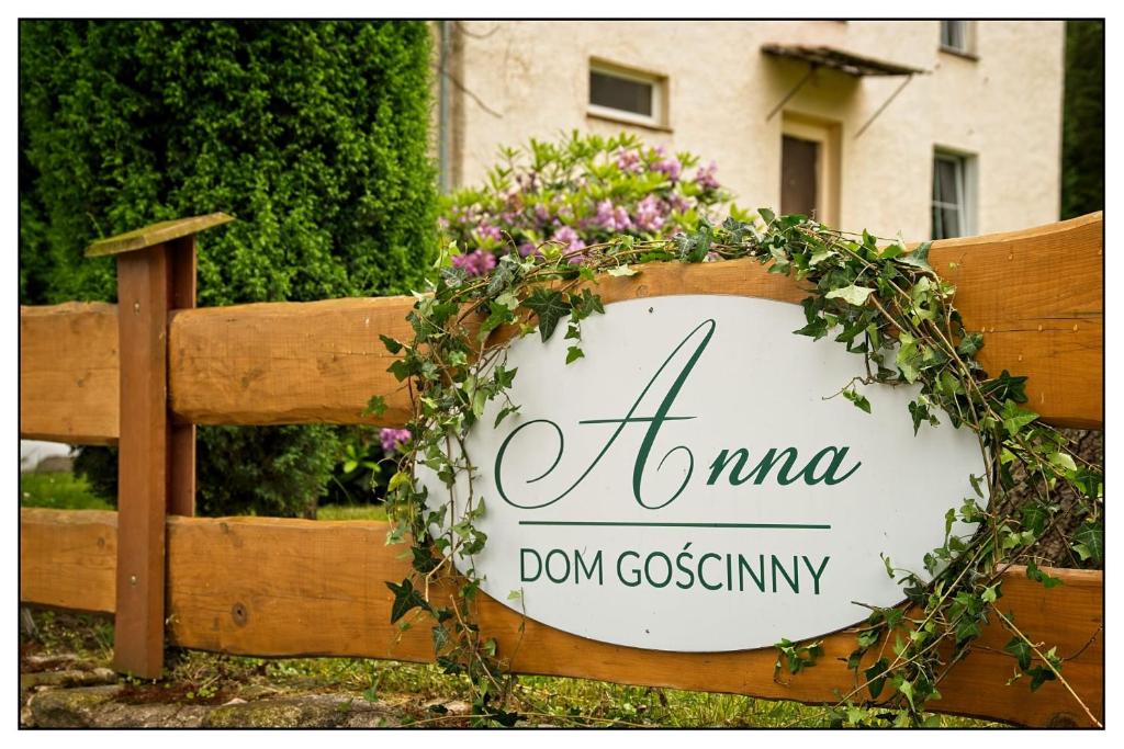 a wreath on a fence with a sign on it at Anna in Miłków