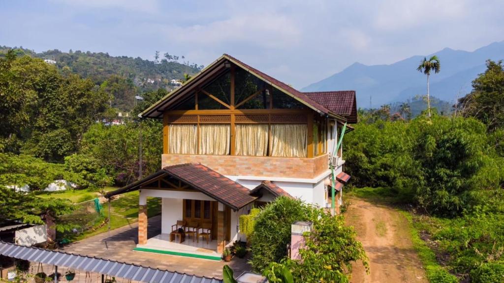 a house on a hill with a view at Glendale Hospitality Wayanad in Vythiri