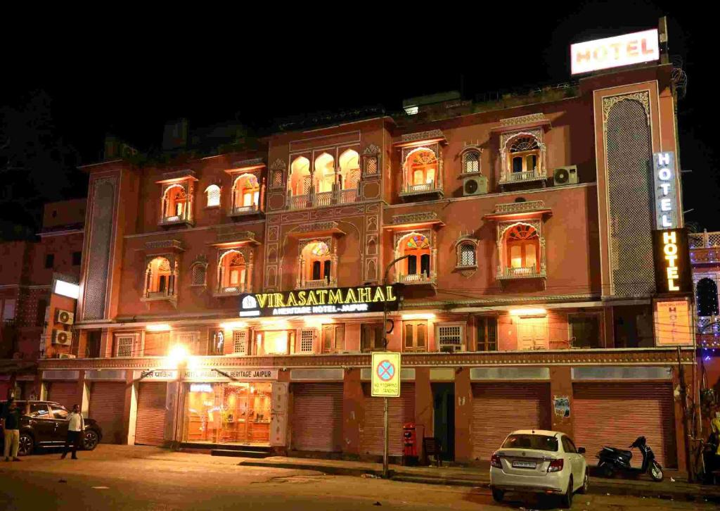 a building with a sign in front of it at night at Virasat Mahal Heritage Hotel in Jaipur