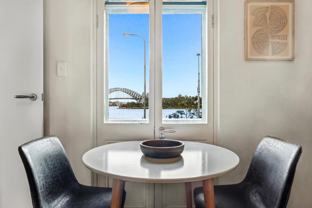 a bowl on a table with chairs and a window at Balmain Wharf 1 bedroom Apartments in Sydney