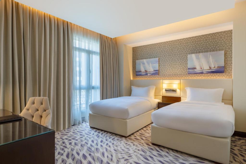 Postel nebo postele na pokoji v ubytování Riviera Rayhaan by Rotana Doha