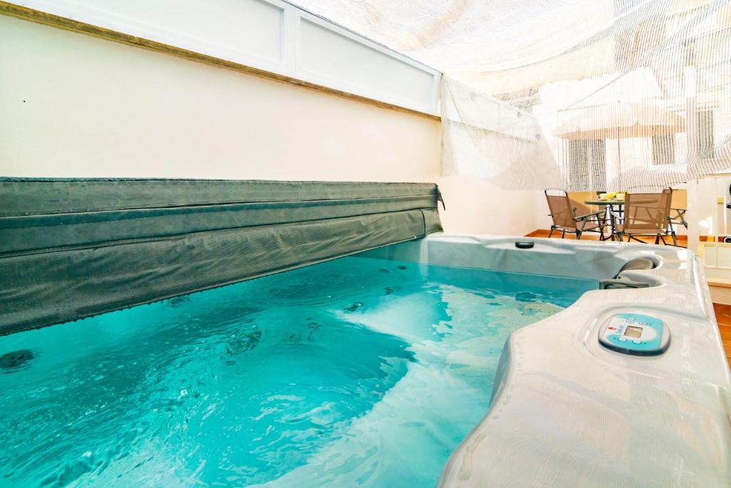 a large swimming pool in a house with a hot tub at Centric in Palma de Mallorca