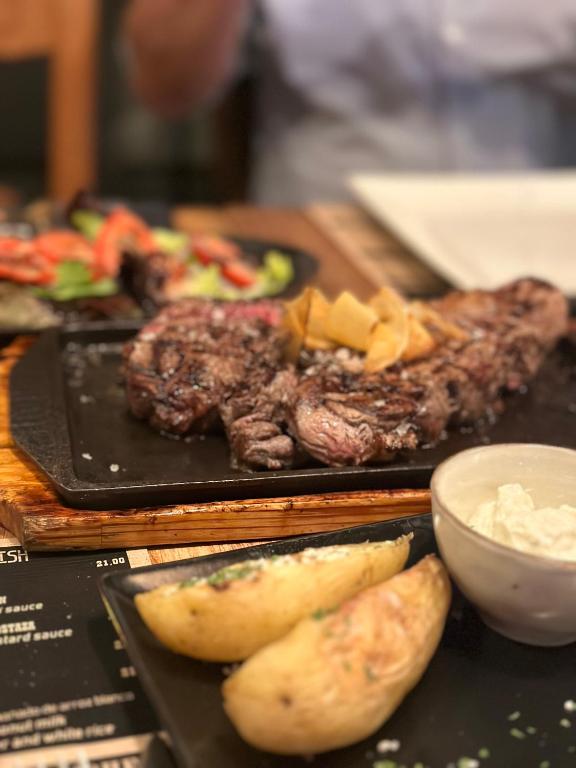 a table with two plates of food with meat and potatoes at Estepona Center in Estepona