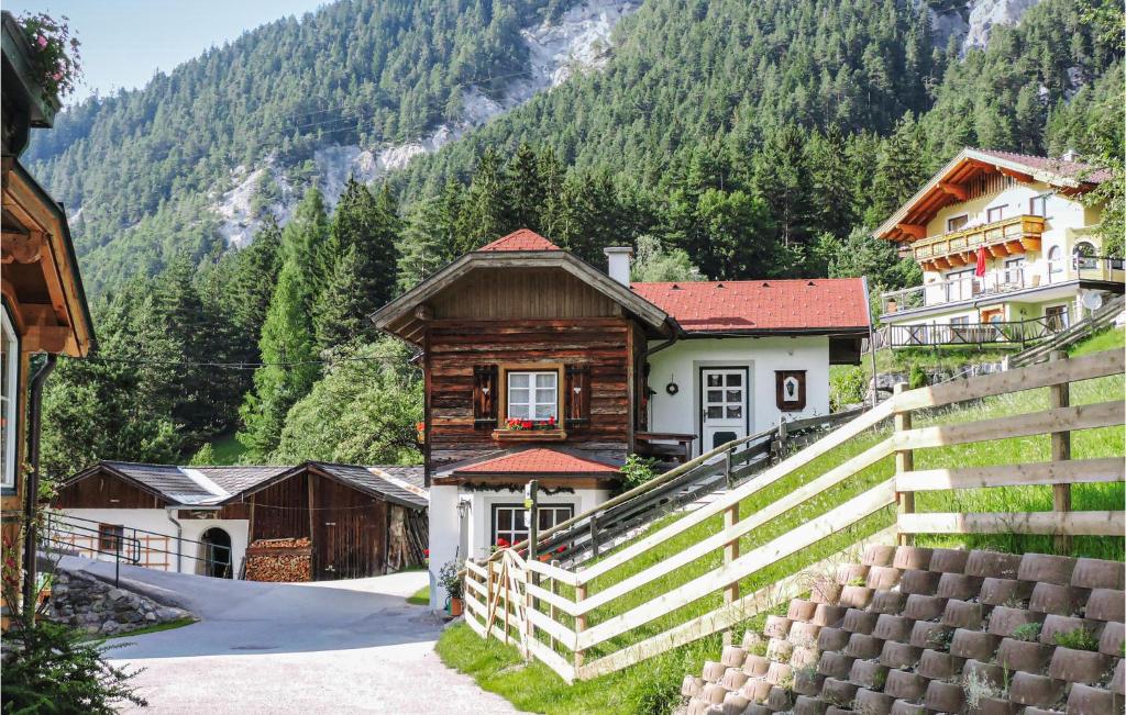 a building with a fence in front of a mountain at 2 Bedroom Gorgeous Home In Schladming in Schladming