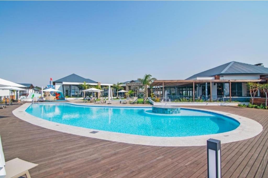 a large swimming pool in the middle of a resort at Coastal Retreats in Ballito