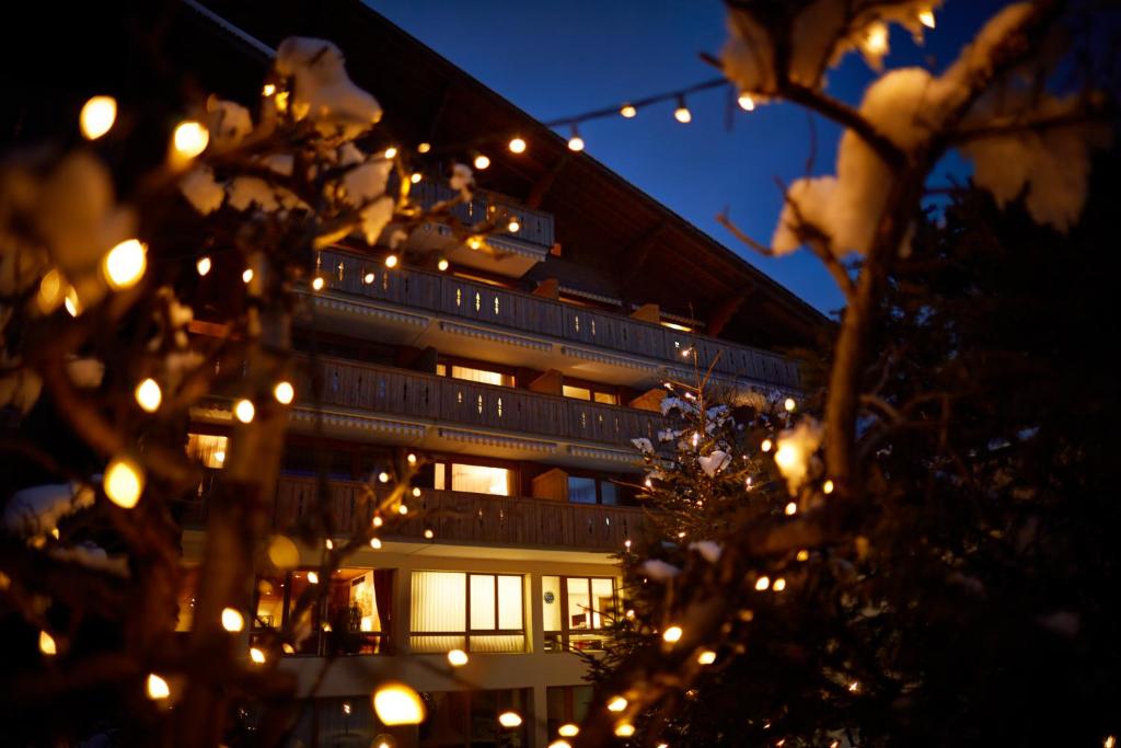 a building with christmas lights in front of it at Apartment Gstaaderhof in Gstaad
