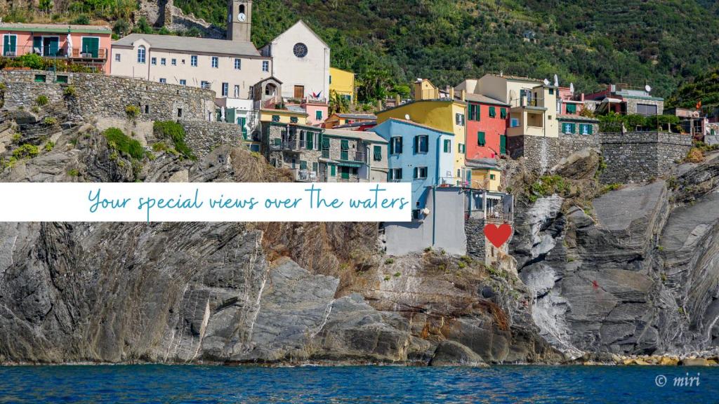 a town on a cliff next to the water at Unda de Ma Sea View Terrace Apartment in Vernazza