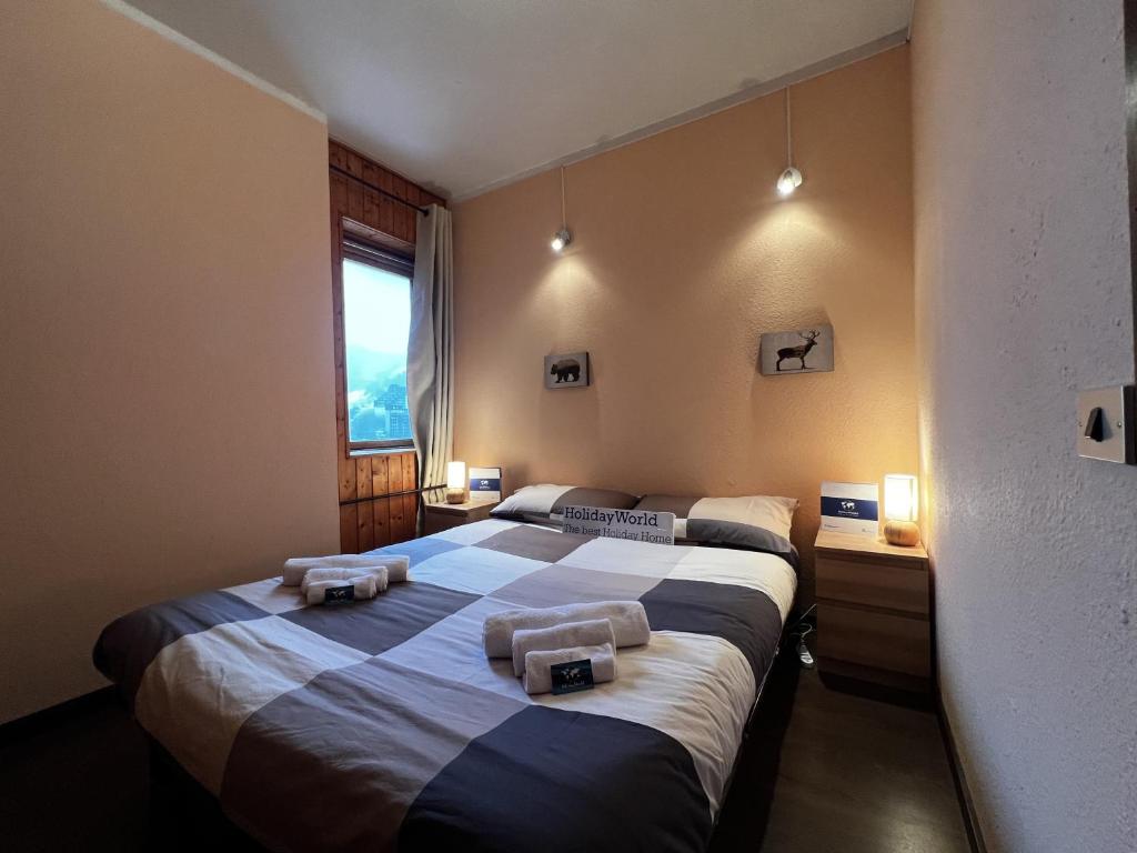 a bedroom with two beds with towels on them at House Betulle by Holiday World in Sella della Turra