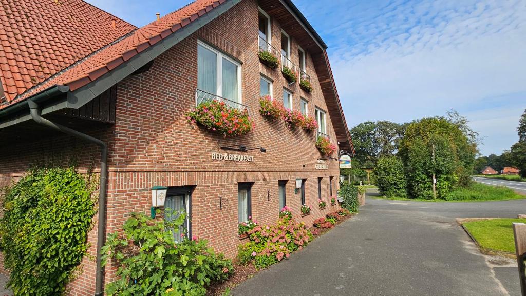 a brick building with flower boxes on the side of it at Gästehaus Grunewald Bed & Breakfast in Heiden