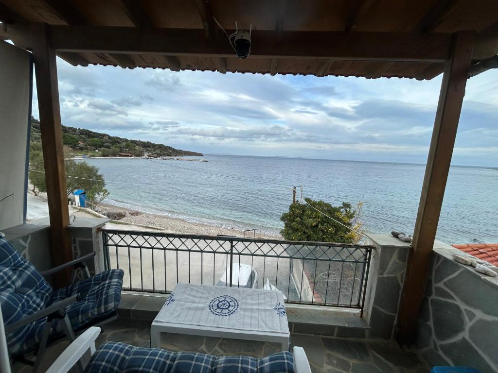 a balcony with a table and a view of the beach at Vikis Dream Views in Skala Mistegnon