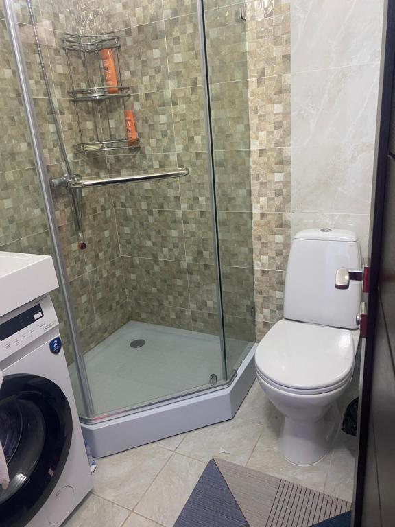 a bathroom with a shower with a toilet at Таунхаус в Baytur Resort in Bosteri