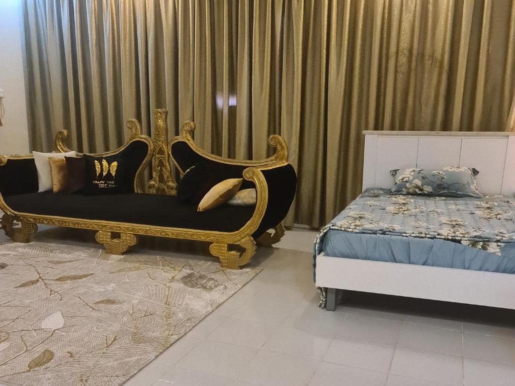 a bedroom with a king sized bed and a bed frame at بيت الياسمين2 in Al Madinah