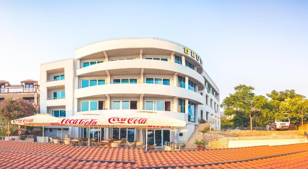 a building with a coca cola sign in front of it at Apartments Deus in Dobra Voda