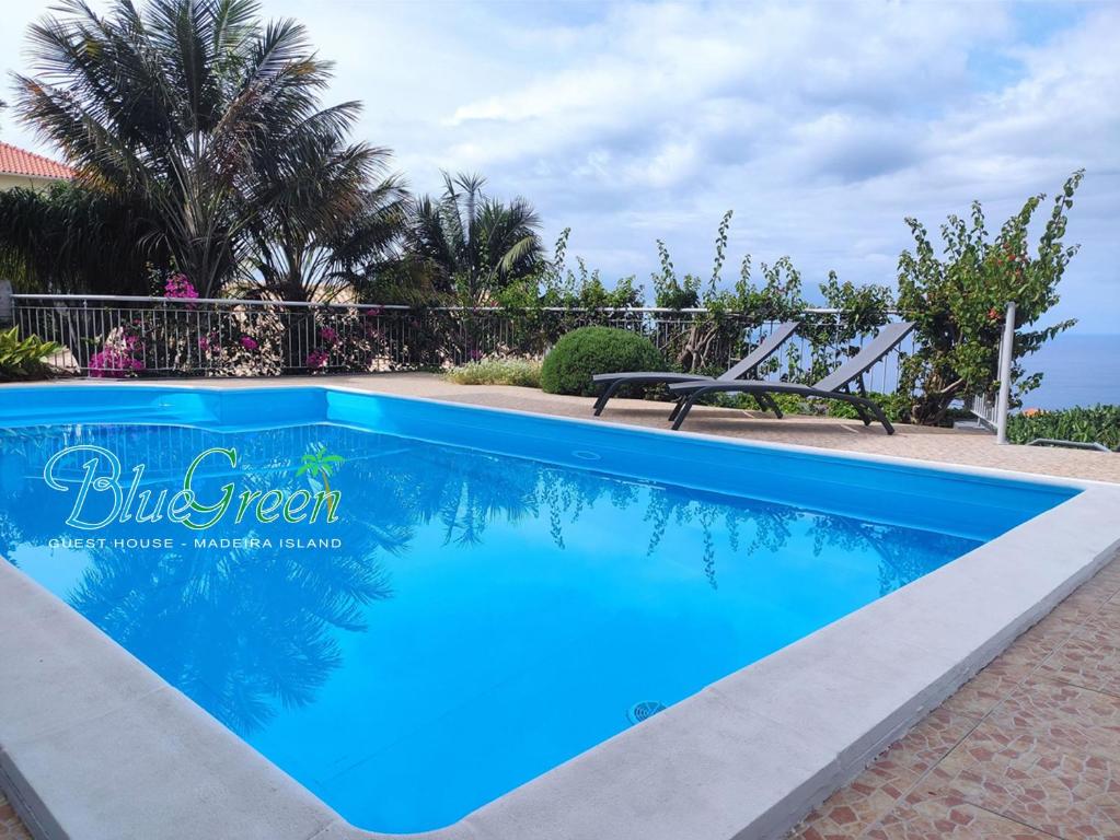 a blue swimming pool in front of a fence at bluegreen in Arco da Calheta