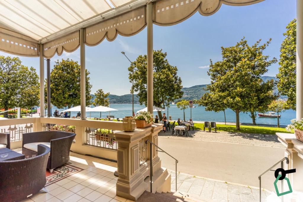 a patio with a view of the water at HOTIDAY Hotel Verbania in Verbania