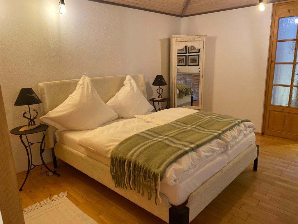 a bedroom with a bed with white sheets and pillows at Annahof in Argenbühl