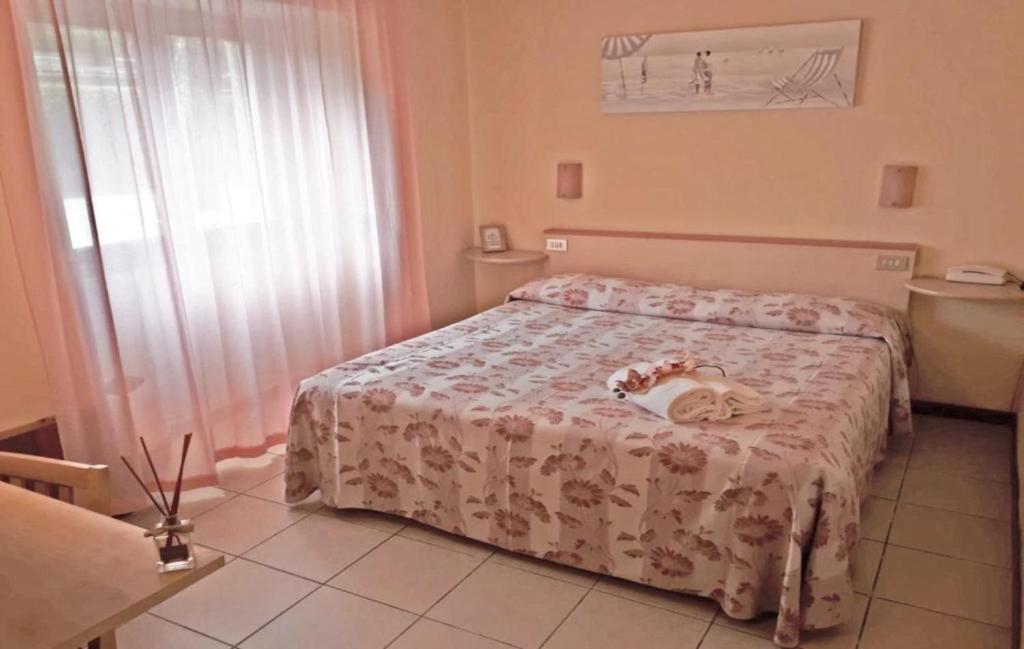 a small bedroom with a bed with a white bedspread at Storyville Simple Stay in Cinquale
