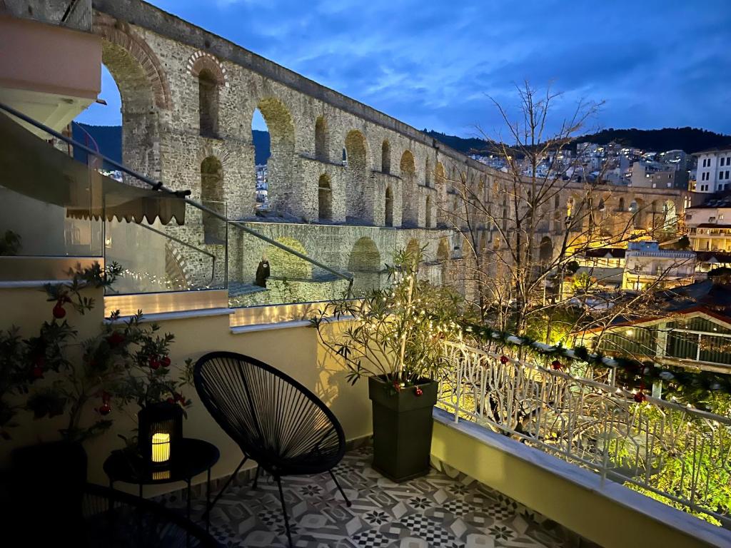a balcony with a view of a building at Under the Aqueduct boutique house in Kavála