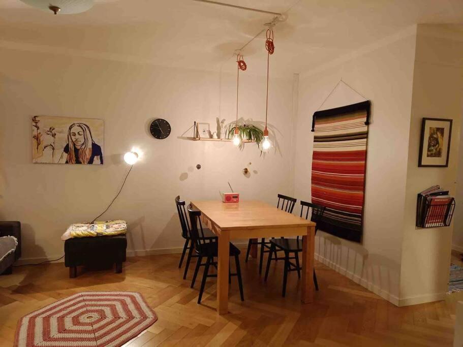 a dining room with a wooden table and chairs at Scandinavian design apartment in the center in Rovaniemi