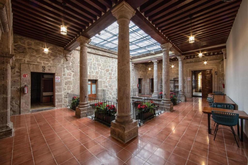 a large building with a glass ceiling and a lobby at OYO Hostal Mich in Morelia