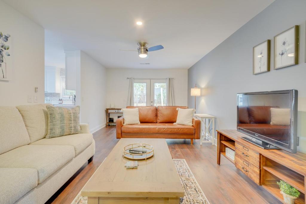 a living room with a couch and a tv at North Charleston Escape about 15 Mi to Dtwn Charleston in Charleston