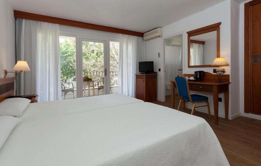 A bed or beds in a room at Hotel Araxa - Adults Only