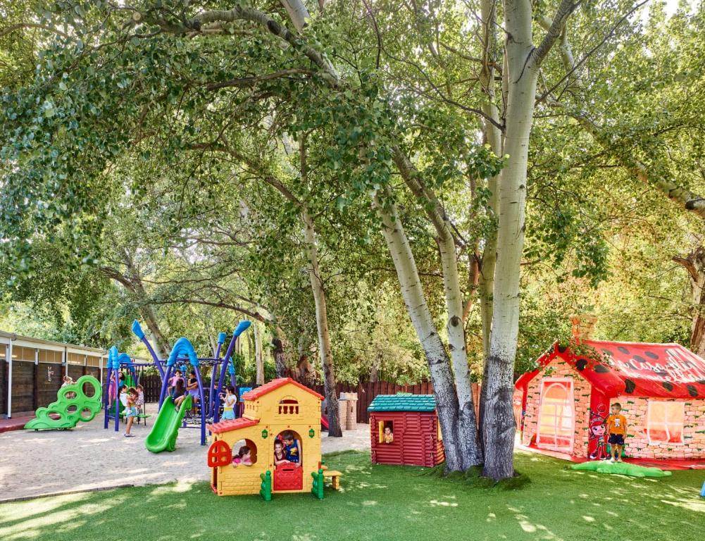 a park with a playground and play equipment at Calaserena Resort in Geremèas