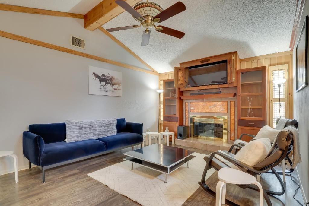 a living room with a blue couch and a fireplace at Round Rock Home with Large Yard 20 Mi to Austin! in Round Rock