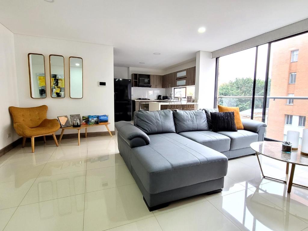 a living room with a couch and a table at New Luxury 3 Bedroom Apartment in Great Area. in Medellín