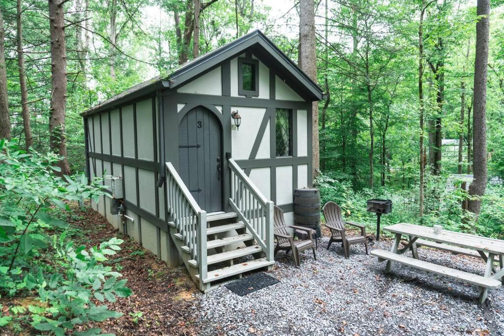 a black and white shed with stairs and a picnic table at Tiny Home Cottage Near the Smokies #3 Ingrid in Sevierville