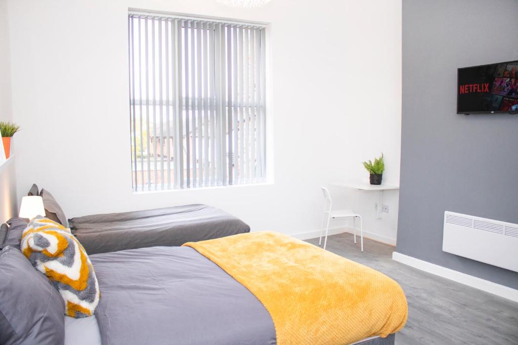 a bedroom with two beds and a window at Chill Nexus Oasis in Liverpool