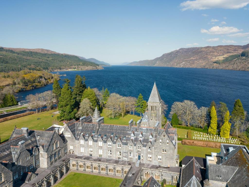 an aerial view of a castle with a lake at 2 Bed in Fort Augustus 80700 in Fort Augustus