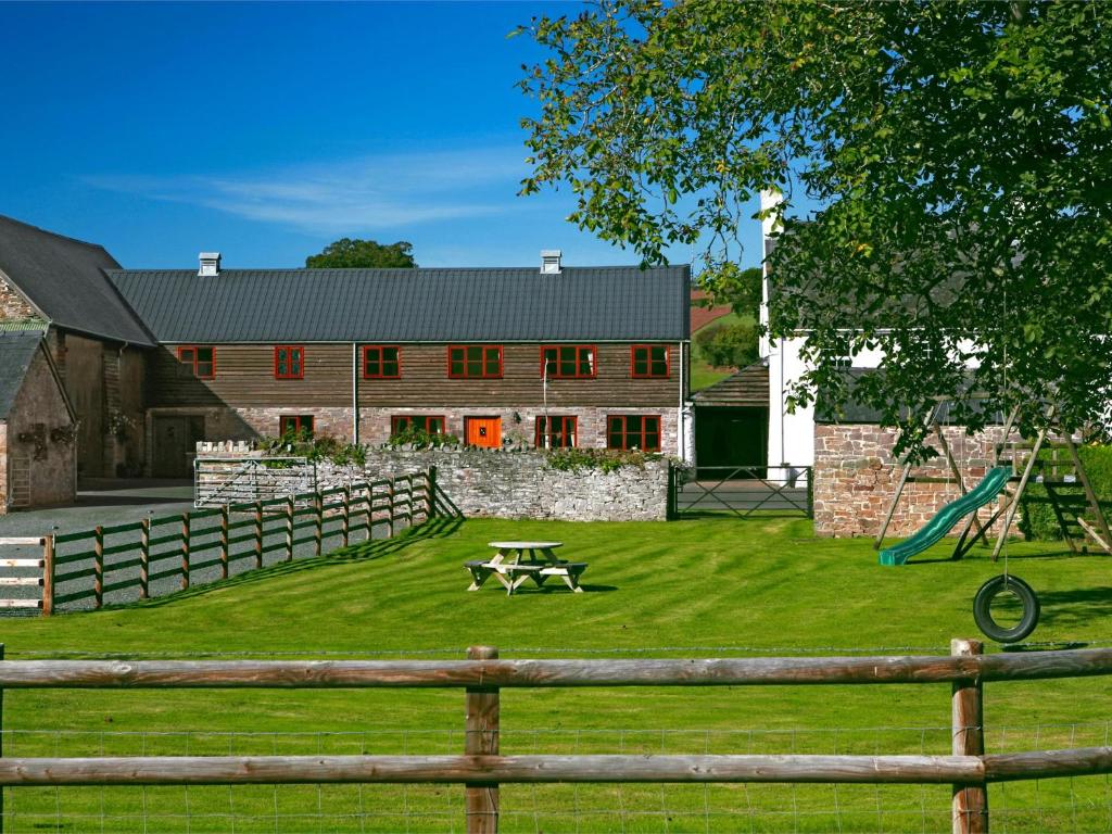 a barn with a picnic table and a playground at 5 Bed in Hay on Wye BN358 in Llyswen