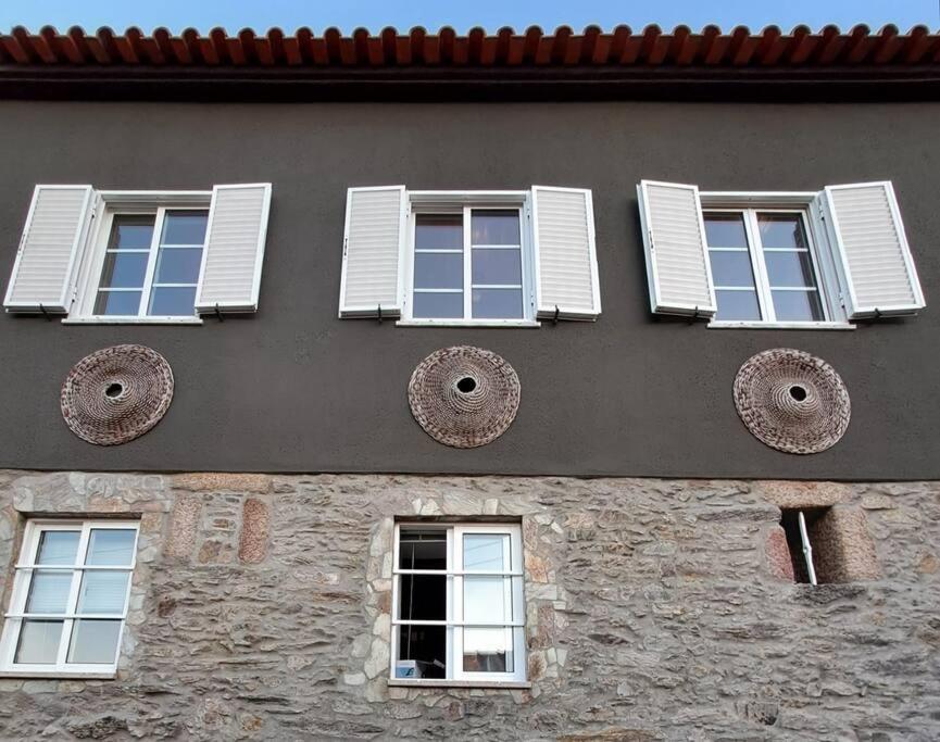 a building with windows and shutters on it at BABhouse Lagar Antigo - Coração do Douro in Nagoselo do Douro