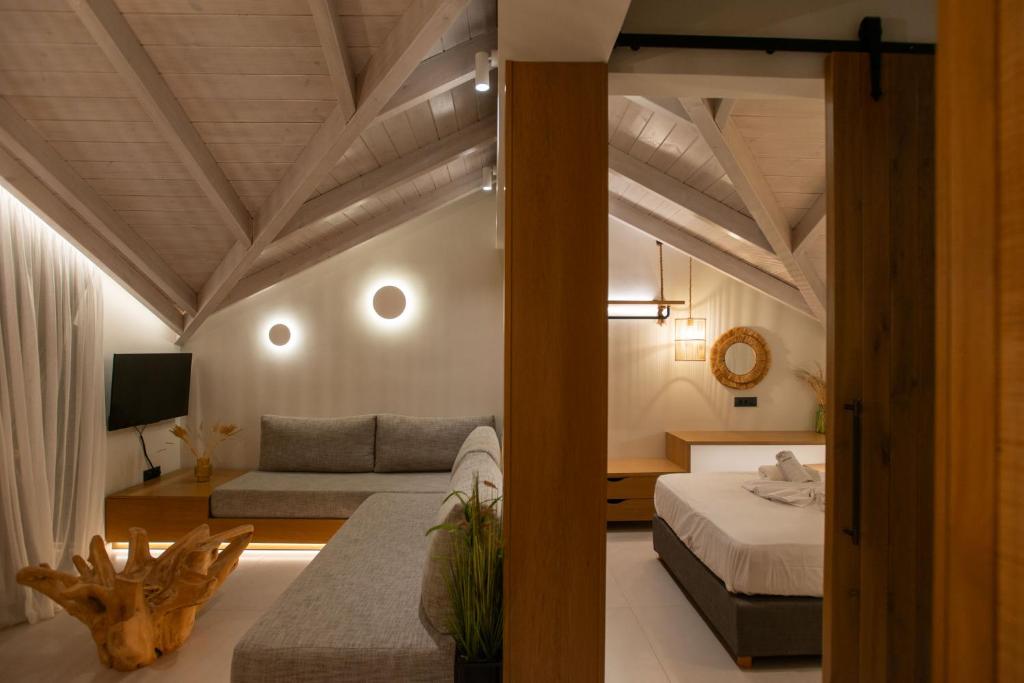 a room with two beds and a couch in it at YOLO Resort - Loft in Alykes