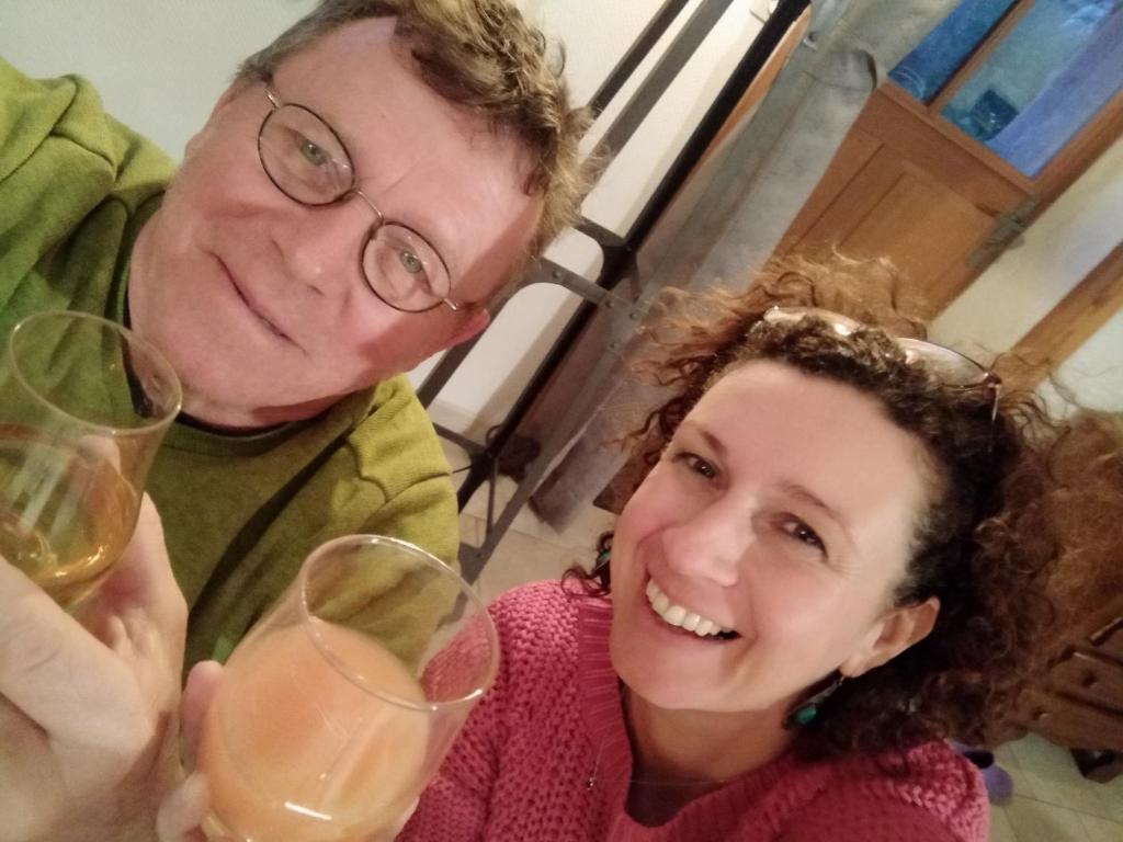 a man and a woman holding glasses of wine at gîte St Pierre in Melle