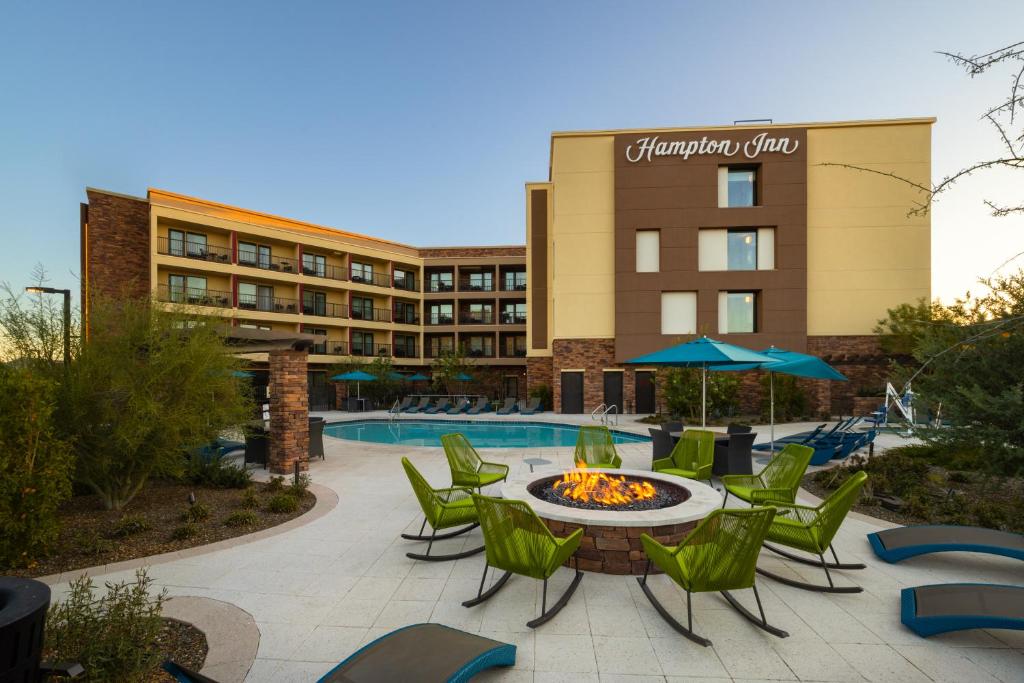 a hotel patio with a table and chairs and a pool at Hampton Inn Carefree, Az in Carefree