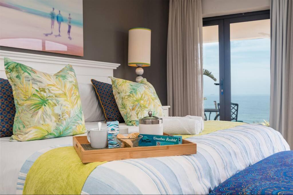 a bedroom with a bed with a view of the ocean at Lalaria Ocean Villa Suite 3 in Ballito