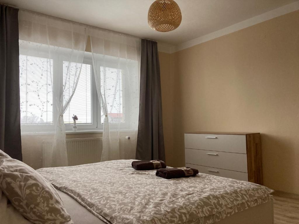 a bedroom with a bed with two towels on it at Apartment In The Garden in Držovice