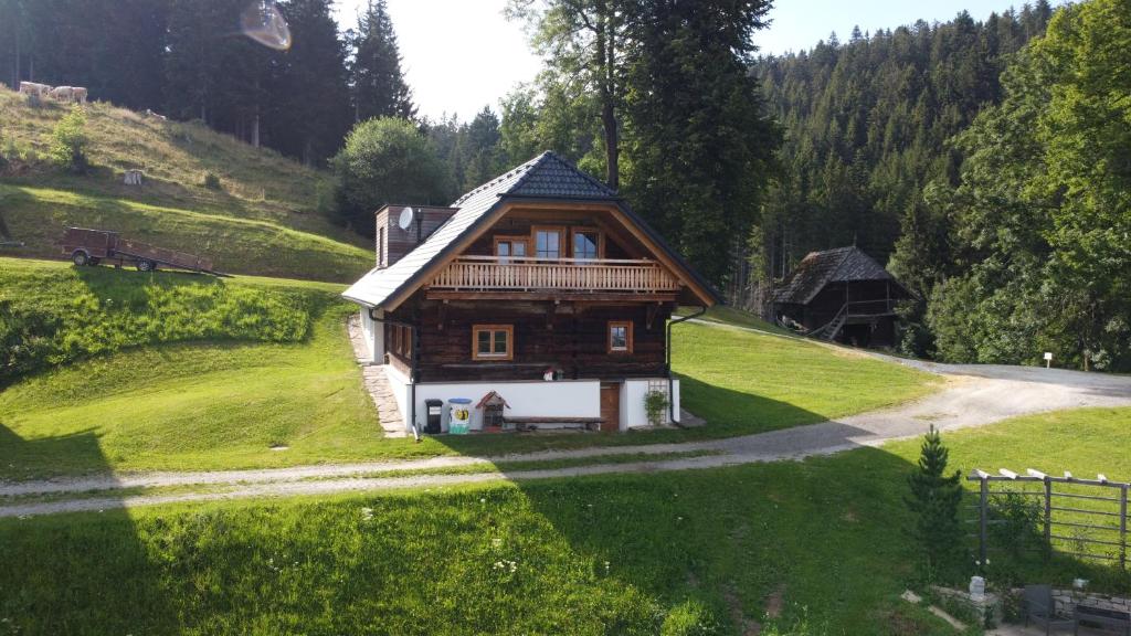 a small wooden house on a hill in a field at Beim Bergbauer in Fischbach