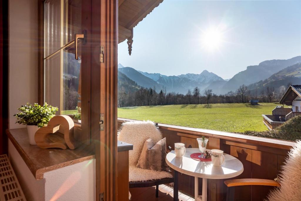 a balcony with a table and a view of a field at Ferienwohnung Garber in Zell am Ziller